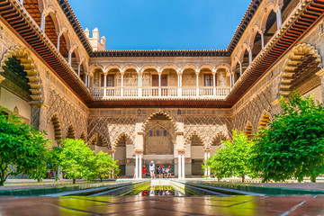 Moorish architecture of beautiful castle called Real Alcazar in Seville, Spain - obrazy, fototapety, plakaty