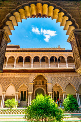 Moorish architecture of beautiful castle called Real Alcazar in Seville, Spain
