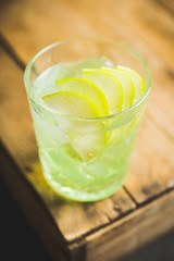 Green apple beverage on the rustic background. Selective focus.