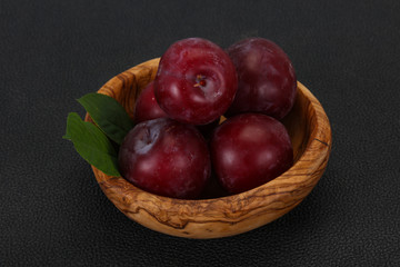 Plum heap in the wooden basket