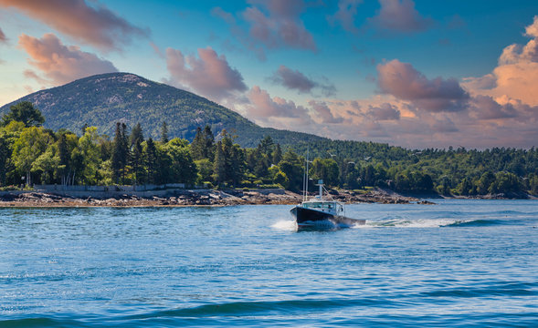 A Black Fishing Boat Cutting Through Blue Maine Water