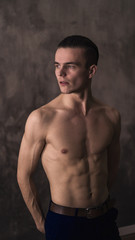Fototapeta premium young athletic guy looks away with a serious face