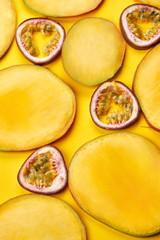 Vertical flat layout of mango slices on yellow paper background