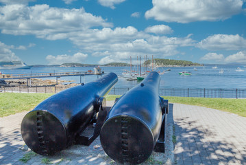Two cannons aimed at sailboats in Bar Harbor Maine