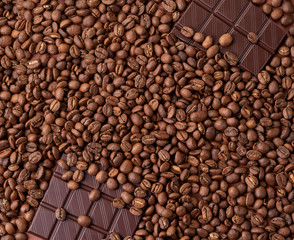 Dark coffee beans with chocolate pieces