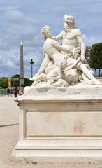 Fototapeta na wymiar Copy of La Seine et la Marne 1712 statue, original by Nicolas Coustou (1658-1733), at Jardin des Tuileries with the Obelisque de Louxor. Paris, France. 