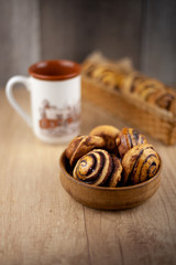 Fototapeta na wymiar Round homemade cookies on the table. Striped cookies with cocoa and cinnamon. Appetizing rolls for a cup of coffee for breakfast. Wooden background in place for text. Food and drink.
