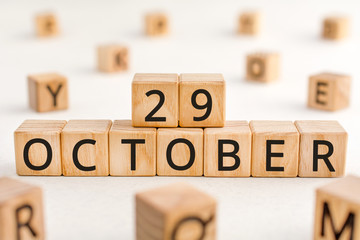October 29 - from wooden blocks with letters, important date concept, white background random letters around