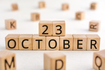 October 23 - from wooden blocks with letters, important date concept, white background random letters around