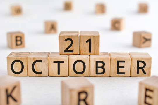 October 21 - from wooden blocks with letters, important date concept, white background random letters around