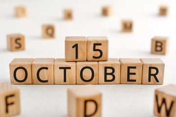 October 15 - from wooden blocks with letters, important date concept, white background random letters around