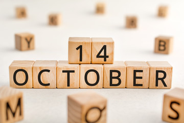 October 14 - from wooden blocks with letters, important date concept, white background random letters around