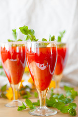 Glasses of homemade cold juice with mint with fresh berries on a light background. Selective focus.