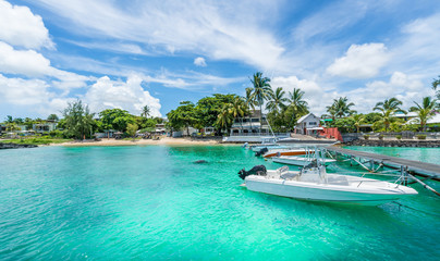 Fototapeta na wymiar Landscape with turquoise water amd speed boats in Mauritius island, Africa