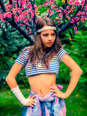 beautiful brunette girl in short striped blue and white shirt, swimsuit and pore on the street in...