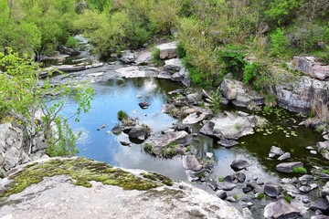 Amazing granite Buky canyon Cherkasy region, Ukraine. Granite canyon in Buki. Ukrainian landmarks. Domestic tourism. Sheer banks and a mountain river, extreme tourism. River rafting
