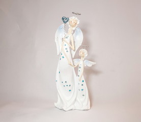 Figurines of two white funny porcelain angels (not  work of authorship. Stamping, consumer goods)