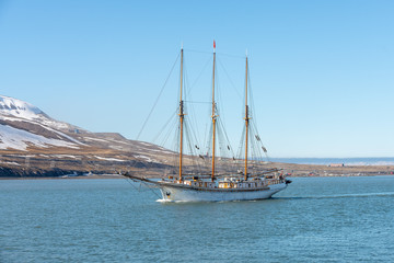 Fototapeta na wymiar Sailing ship at anchor on Longyearbyen, Svalbard. Passenger cruise vessel. Arctic and Antarctic cruise.