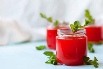 Glasses of homemade cold juice with mint with fresh berries on a light background. Selective focus.