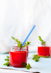 Glasses of homemade cold juice with mint with fresh berries on a light background. Selective focus.