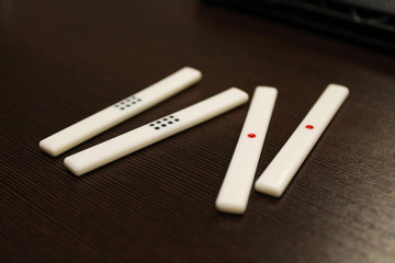 Counting sticks for mahjong are on the table, the back and side plans are blurred. Table...