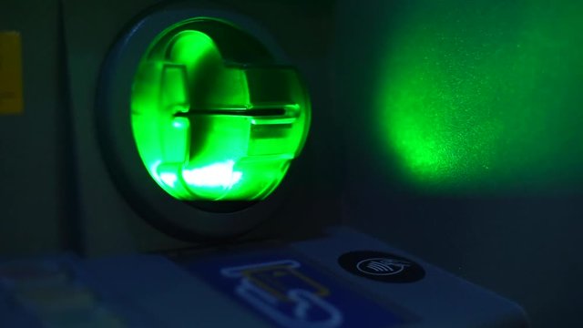 Cash withdrawal at an ATM. Close-up of a card receiver at an ATM. Blinks green. Ready for work.