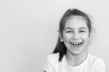 Portrait of happy laughing child girl. Smiling kid. Positive emotions. Black and white image