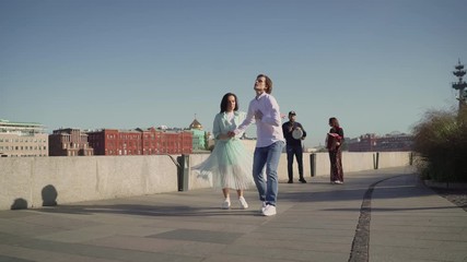 Dancers are dancing a Spanish dance on the river embankment. Street musicians and dancers.