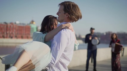 Dancers are dancing a Spanish dance on the river embankment. Street musicians and dancers.