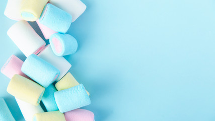 bright multi-colored marshmallows on a blue background