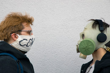 one on one versus confrontation of two man portrait in face respirator mask from diseases and...