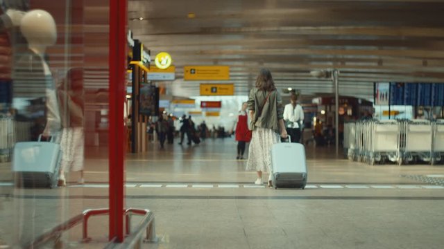 Young girl with a suitcase at the airport, Moscow