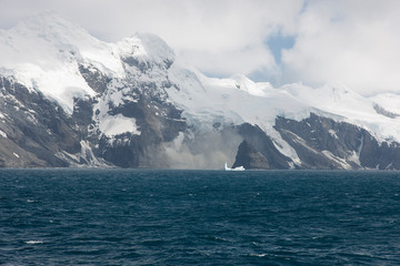 Antarctica landscape with ocean and mountains on a clear winter day
