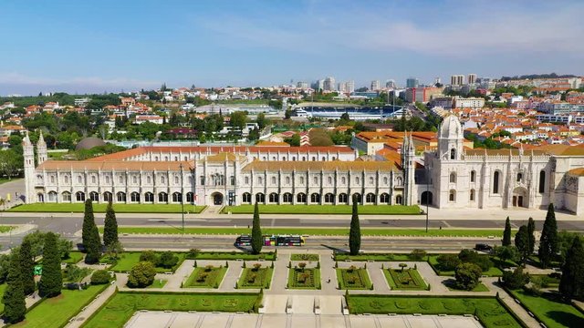 Aerial, pull back, drone shot over the Praca do Imperio square and the Monsteiro dos Jeronimos, sunny day, in Belem, Lisbon, Portugal - Empty due to Coronavirus