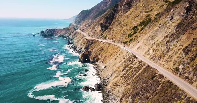 A car driving along the Pacific Highway coast. Aerial tracking shot
