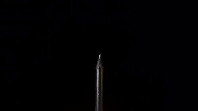 Thin Black Charcoal Pencil Push Out On Black Background - Slow Motion