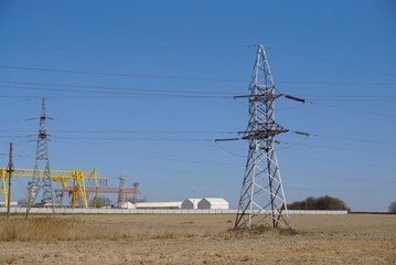 Electricity pylon on the background of an industrial enterprise