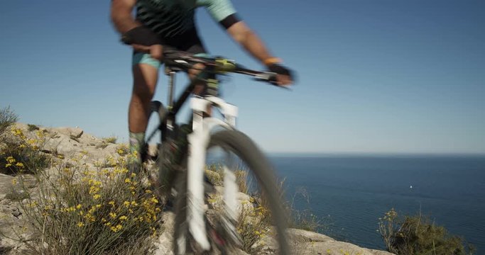 Mountain biker over extreme terrain, Alicante city coast, Spain, Europe