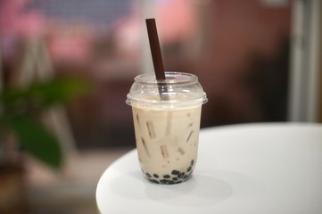 Pearl milk tea in a cup at the cafe