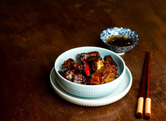 aian food, caramelized pork ribs, dark   wooden background, chinese food