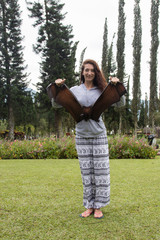 The girl holds a flying fox by the wings. Danger, animal, cute, bat, exotic, mammals, tropics, wings, contact