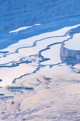 Blue steamy water of the spring in limestone pools in Pamukkale, Turkey