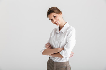Image of young laughing woman posing with hands crossed on camera