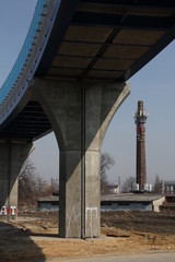 A fragment of a railway overpass in an industrial landscape.