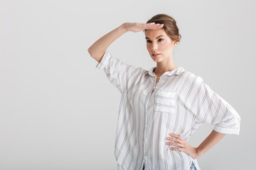 Image of caucasian woman looking aside with hand on her forehead