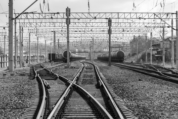 Compositions with tanks with fuel on diverging railway tracks at a freight station.