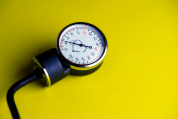 Blood pressure gauge on a yellow background