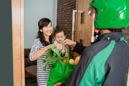 Woman And Baby Shopping Grocery Online And Delivered By Courier At Home