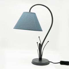 A modern table lamp with a blue lampshade and a metal base, cut out on white background