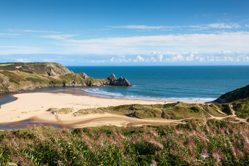 Three Cliffs Bay on the Gower Peninsular West Glamorgan Wales which is a popular Welsh coastline attraction travel destination of outstanding beauty in the UK - obrazy, fototapety, plakaty